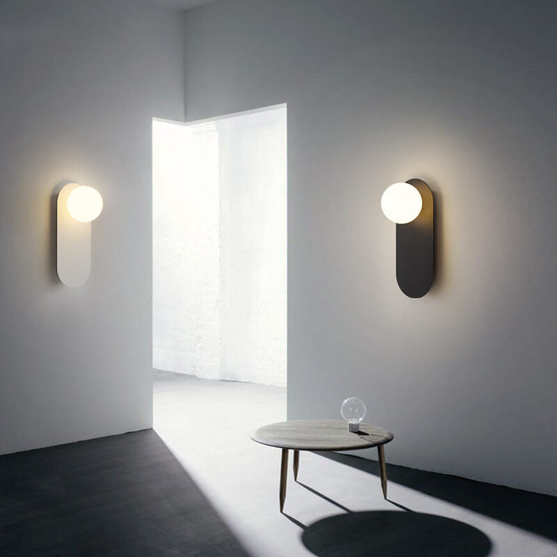 Minimalist Nordic globe wall sconce with oval backplate by BROKLEN