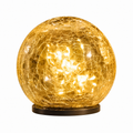 Solar crackle glass globe garden light glowing at night