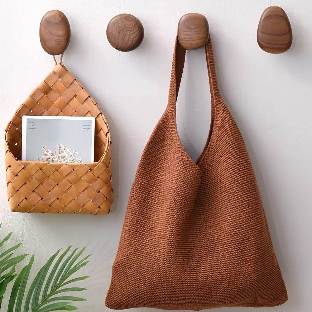 Set of four round pebble shaped wooden wall hooks by BROKLEN